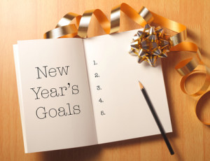 New Year's goals with gold color decorations. New Year’s goals are resolutions or promises that people make for the New Year to make their upcoming year better in some way.